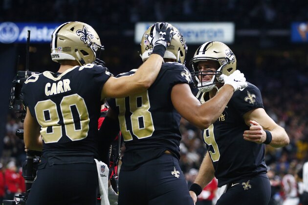 New Orleans Saints quarterback Drew Brees (9) and wide receiver Austin Carr (80) celebrate with wide receiver Keith Kirkwood (18) after Brees' touchdown pass to Kirkwood in the second half of an NFL football game against the Atlanta Falcons in New Orleans, Thursday, Nov. 22, 2018. (AP Photo/Butch Dill)