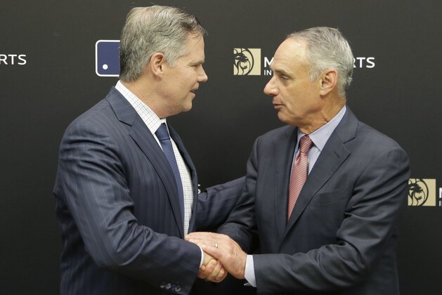 MGM Resorts CEO James Murren, left, and MLB Commissioner Rob Manfred shake hands after a news conference at MLB headquarters in New York, Tuesday, Nov. 27, 2018. (AP Photo/Seth Wenig)