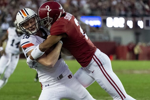 Alabama defensive back Patrick Surtain II (2) hits Auburn place-kicker Anders Carlson (26) to stop Auburn on a fake field goal on fourth down during the second half of an NCAA college football game Saturday, Nov. 24, 2018, in Tuscaloosa, Ala. (AP Photo/Vasha Hunt)