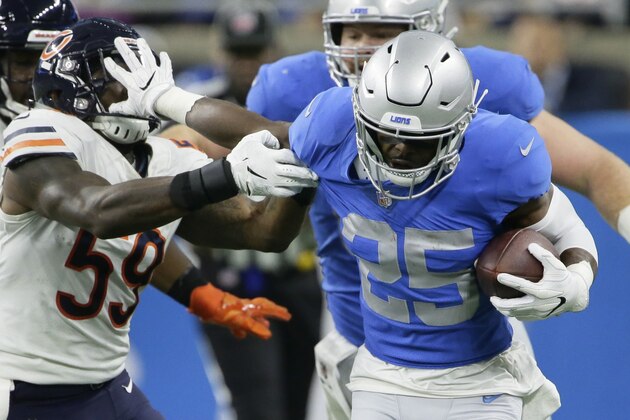 Detroit Lions running back Theo Riddick (25) stiff arms Chicago Bears inside linebacker Danny Trevathan (59) during the first half of an NFL football game, Thursday, Nov. 22, 2018, in Detroit. (AP Photo/Duane Burleson)