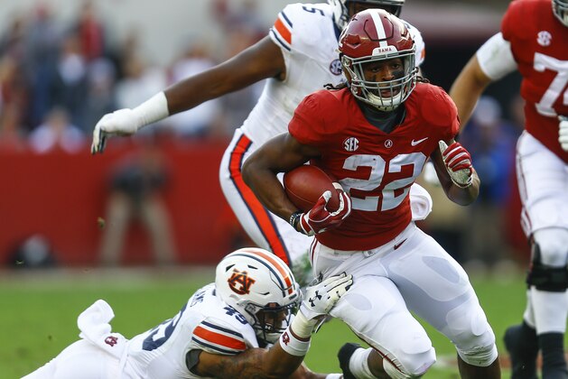 Alabama running back Najee Harris (22) carries the ball as Auburn linebacker Darrell Williams (49) tries to tackle him during the first half of an NCAA college football game, Saturday, Nov. 24, 2018, in Tuscaloosa, Ala. (AP Photo/Butch Dill)