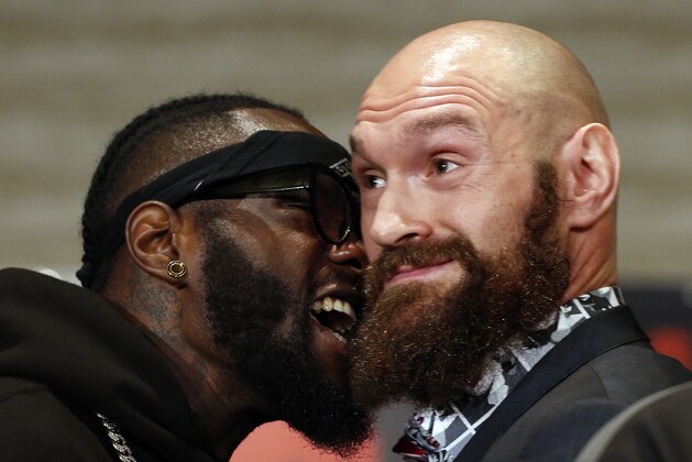 Boxers Deontay Wilder, left, and Tyson Fury exchange words as they face each other at a news conference in Los Angeles, Wednesday, Nov. 28, 2018, ahead of their heavyweight world championship boxing match in Los Angeles on Dec. 1, at Staples Center. (AP Photo/Damian Dovarganes)