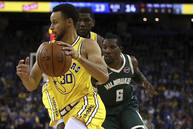 Golden State Warriors' Stephen Curry drives the ball past Milwaukee Bucks' Eric Bledsoe (6) during the first half of an NBA basketball game Thursday, Nov. 8, 2018, in Oakland, Calif. (AP Photo/Ben Margot)