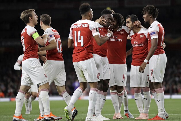 Arsenal's Danny Welbeck, center, is celebrated after scoring his side's second goal during the Europa League Group E soccer match between Arsenal and Vorskla in London, England, Thursday, Sept. 20, 2018. (AP Photo/Kirsty Wigglesworth)