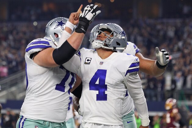 ARLINGTON, TEXAS - NOVEMBER 22: Zack Martin #70 celebrates the fourth quarter touchdown by Dak Prescott #4 of the Dallas Cowboys  against the Washington Redskins at AT&T Stadium on November 22, 2018 in Arlington, Texas. (Photo by Richard Rodriguez/Getty Images)