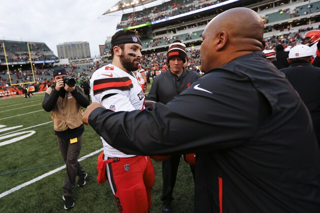 FILE - In this Sunday, Nov. 25, 2018, file photo, Cleveland Browns quarterback Baker Mayfield (6) meets with Cincinnati Bengals special assistant Hue Jackson, right, after an NFL football game in Cincinnati. Mayfield said he doesn’t regret calling former Browns coach Hue Jackson