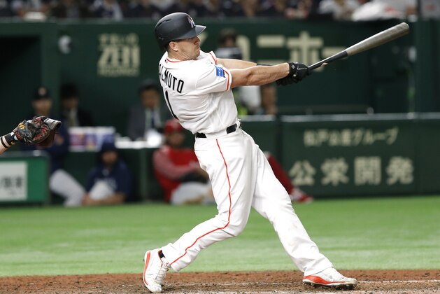 MLB All-Star catcher J.T. Realmuto of the Miami Marlins hits a three-run home-run off All Japan's pitcher Masaru Sato in the eighth inning of Game 2 of their All-Stars Series baseball at Tokyo Dome in Tokyo, Saturday, Nov. 10, 2018. (AP Photo/Toru Takahashi)