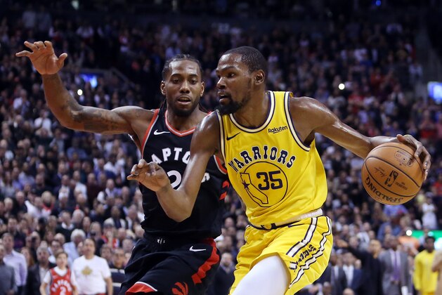 TORONTO, ON - NOVEMBER 29:  Kevin Durant #35 of the Golden State Warriors dribbles the ball as Kawhi Leonard #2 of the Toronto Raptors defends during the second half of an NBA game at Scotiabank Arena on November 29, 2018 in Toronto, Canada.  NOTE TO USER: User expressly acknowledges and agrees that, by downloading and or using this photograph, User is consenting to the terms and conditions of the Getty Images License Agreement.  (Photo by Vaughn Ridley/Getty Images)