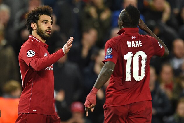 Liverpool's Egyptian midfielder Mohamed Salah (L) celebrates with Liverpool's Senegalese striker Sadio Mane after scoring their second goal during the UEFA Champions League group C football match between Liverpool and Red Star Belgrade at Anfield in Liverpool, north west England on October 24, 2018. (Photo by Oli SCARFF / AFP)        (Photo credit should read OLI SCARFF/AFP/Getty Images)