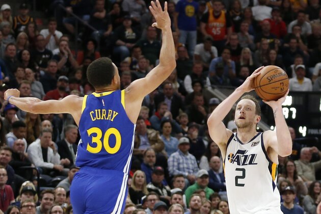 Utah Jazz forward Joe Ingles (2) shoots as Golden State Warriors guard Stephen Curry (30) defends in the second half during an NBA basketball game Friday, Oct. 19, 2018, in Salt Lake City. (AP Photo/Rick Bowmer)