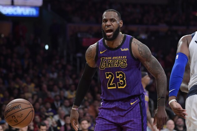 Los Angeles Lakers forward LeBron James reacts after scoring during the second half of the team's NBA basketball game against the Dallas Mavericks on Friday, Nov. 30, 2018, in Los Angeles. The Lakers won 114-103. (AP Photo/Mark J. Terrill)