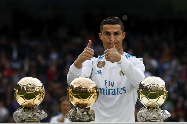 MADRID, SPAIN - DECEMBER 09: Cristiano Ronaldo of Real Madrid CF poses with his five Golden Ball (Ballon d'Or) trophies   prior to start the La Liga match between Real Madrid CF and Sevilla FC at Estadio Santiago Bernabeu on December 9, 2017 in Madrid, Spain . (Photo by Gonzalo Arroyo Moreno/Getty Images)