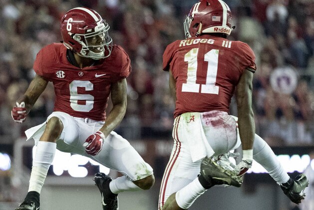 FILE - In this Saturday, Nov. 24, 2018, file photo, Alabama wide receivers DeVonta Smith (6) and Henry Ruggs III (11) celebrate a touchdown reception by Ruggs during the second half of an NCAA college football game against Auburn in Tuscaloosa, Ala. The Tide hasn't had a Top 15 offense under coach Nick Saban. Enter Tua Tagovailoa. And Jerry Jeudy. And fellow receivers Henry Ruggs III, DeVonta Smith and freshman Jaylen Waddle. Plus tight end Irv Smith Jr. Not to mention tailbacks Damien Harris, Najee Harris and Josh Jacobs.  (AP Photo/Vasha Hunt, File)