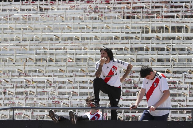Fans of Argentina's River Plate react to the announcement that the final Copa Libertadores soccer match against Argentina's Boca Juniors was suspended, at Antonio Vespucio Liberti stadium in Buenos Aires, Argentina, Sunday, Nov. 25, 2018. South American soccer body CONMEBOL said on Sunday that the second leg of the final will be rescheduled after Boca’s bus was attacked by River fans on Saturday. (AP Photo/Ricardo Mazalan)