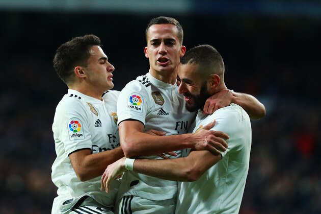 MADRID, SPAIN - DECEMBER 01:  Lucas Vazquez of Real Madrid (C) celebrates after scoring his team's second goal with Karim Benzema (R) and Sergio Reguilon (L) during the La Liga match between Real Madrid CF and Valencia CF at Estadio Santiago Bernabeu on December 01, 2018 in Madrid, Spain. (Photo by Gonzalo Arroyo Moreno/Getty Images)