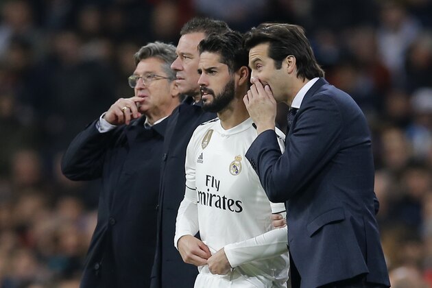 Real Madrid's coach Santiago Solari, right, speaks with Real Madrid's Isco just before Isco came on as substitute during a Spanish La Liga soccer match between Real Madrid and Valencia at the Santiago Bernabeu stadium in Madrid, Spain, Saturday, Dec. 1, 2018. (AP Photo/Paul White)