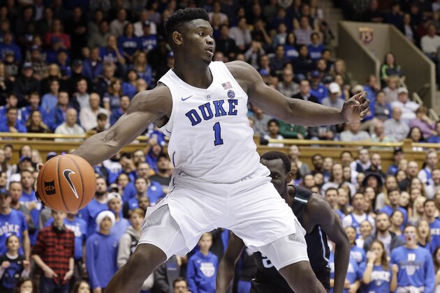 Duke's Zion Williamson (1) saves the ball from going out of bounds while Stetson's Abayomi Iyiola looks on during the first half of an NCAA college basketball game in Durham, N.C., Saturday, Dec. 1, 2018. (AP Photo/Gerry Broome)