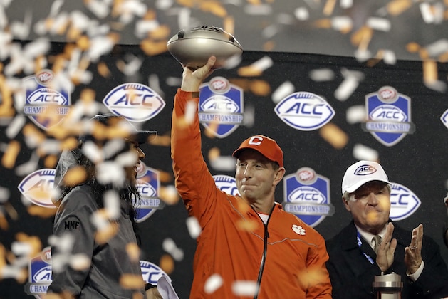 Clemson head coach Dabo Swinney raises the trophy after Clemson won the Atlantic Coast Conference championship NCAA college football game against Pittsburgh in Charlotte, N.C., Saturday, Dec. 1, 2018. (AP Photo/Chuck Burton)