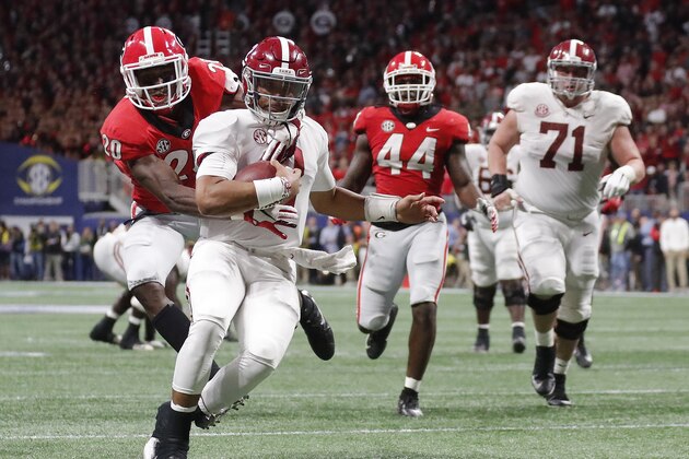 Georgia defensive back J.R. Reed (20) tries to tackle Alabama quarterback Jalen Hurts (2) during the second half of the Southeastern Conference championship NCAA college football game, Saturday, Dec. 1, 2018, in Atlanta. Hurts scored a touchdown on the play. (AP Photo/John Bazemore)
