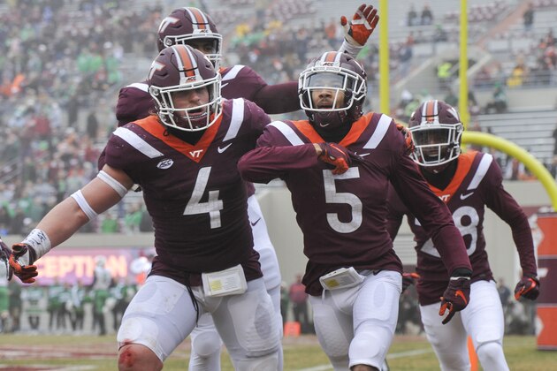 BLACKSBURG, VA - DECEMBER 1: Defensive back Bryce Watts #5 of the Virginia Tech Hokies celebrates his interception against the Marshall Thundering Herd with linebacker Dax Hollifield #4 in the first half at Lane Stadium on December 1, 2018 in Blacksburg, Virginia. (Photo by Michael Shroyer/Getty Images)
