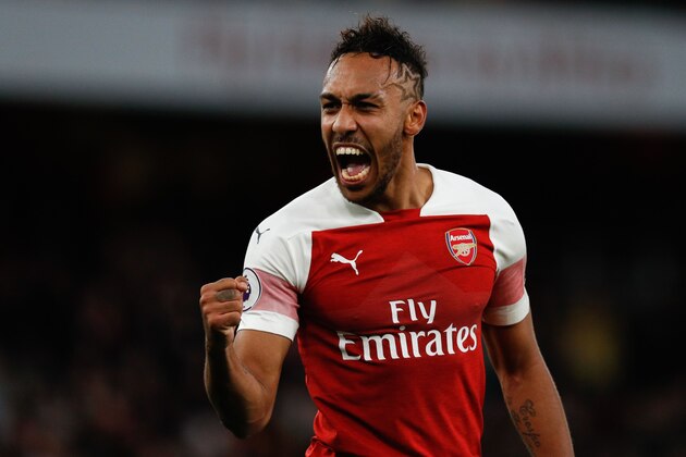 Arsenal's Gabonese striker Pierre-Emerick Aubameyang celebrates on the pitch after the English Premier League football match between Arsenal and Tottenham Hotspur at the Emirates Stadium in London on December 2, 2018. - Arsenal won the game 4-2. (Photo by Adrian DENNIS / AFP) / RESTRICTED TO EDITORIAL USE. No use with unauthorized audio, video, data, fixture lists, club/league logos or 'live' services. Online in-match use limited to 120 images. An additional 40 images may be used in extra time. No video emulation. Social media in-match use limited to 120 images. An additional 40 images may be used in extra time. No use in betting publications, games or single club/league/player publications. /         (Photo credit should read ADRIAN DENNIS/AFP/Getty Images)