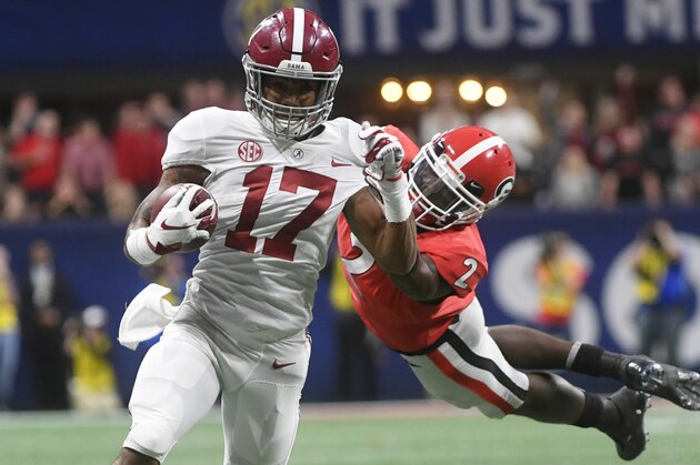 Georgia defensive back Richard LeCounte (2) misses the tackle on Alabama wide receiver Jaylen Waddle (17) during the second half of the Southeastern Conference championship NCAA college football game, Saturday, Dec. 1, 2018, in Atlanta. Waddle scored a touchdown on the play. (AP Photo/John Amis)