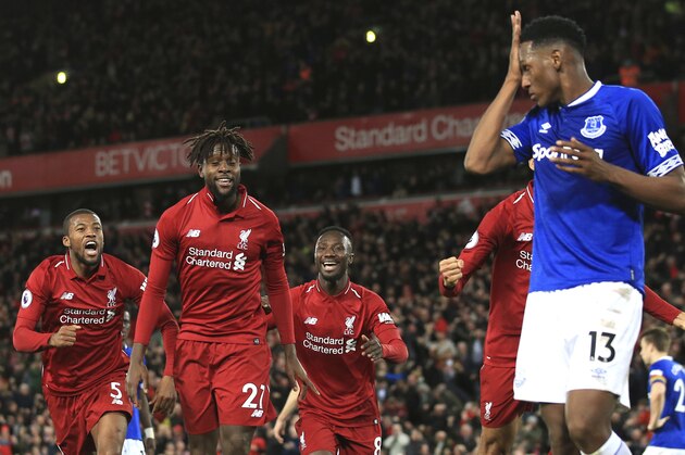 Liverpool forward Divock Origi, second from left, celebrates after scoring his side's first goal during the English Premier League soccer match between Liverpool and Everton at Anfield Stadium in Liverpool, England, Sunday, Dec. 2, 2018. (AP Photo/Jon Super)