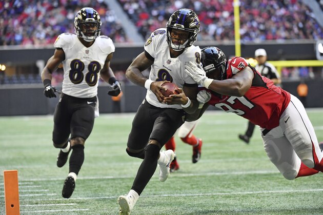 Baltimore Ravens quarterback Lamar Jackson (8) runs into the end zone for a touchdown against Atlanta Falcons defensive tackle Grady Jarrett (97) during the first half of an NFL football game, Sunday, Dec. 2, 2018, in Atlanta. (AP Photo/Danny Karnik)