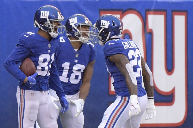 New York Giants wide receiver Russell Shepard, left, celebrates with teammates wide receiver Bennie Fowler (18) and running back Wayne Gallman (22) after catching a touchdown pass from wide receiver Odell Beckham, not pictured, during the second half of an NFL football game against the Chicago Bears, Sunday, Dec. 2, 2018, in East Rutherford, N.J. (AP Photo/Bill Kostroun)