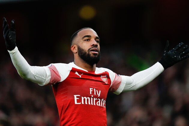Arsenal's French striker Alexandre Lacazette celebrates after scoring their third goal during the English Premier League football match between Arsenal and Tottenham Hotspur at the Emirates Stadium in London on December 2, 2018. (Photo by Adrian DENNIS / AFP) / RESTRICTED TO EDITORIAL USE. No use with unauthorized audio, video, data, fixture lists, club/league logos or 'live' services. Online in-match use limited to 120 images. An additional 40 images may be used in extra time. No video emulation. Social media in-match use limited to 120 images. An additional 40 images may be used in extra time. No use in betting publications, games or single club/league/player publications. /         (Photo credit should read ADRIAN DENNIS/AFP/Getty Images)