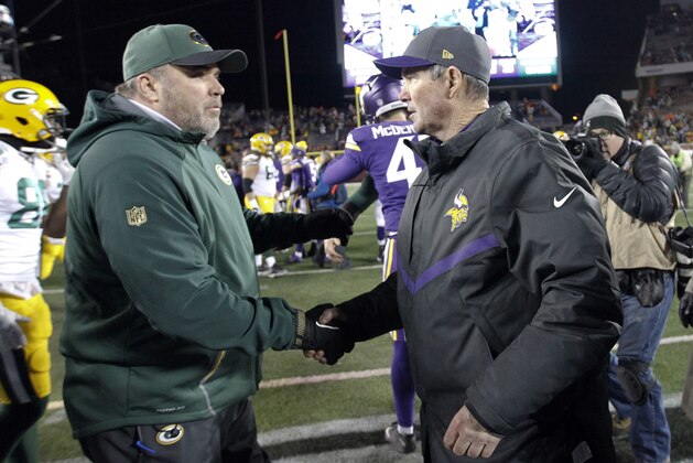 FILE - In this Nov. 22, 2015, file photo, Green Bay Packers head coach Mike McCarthy, left, meets with Minnesota Vikings head coach Mike Zimmer following their NFL football game in Minneapolis. The two teams meet at Lambeau Field on Sunday night to determine the NFC North champion. (AP Photo/Ann Heisenfelt, File)