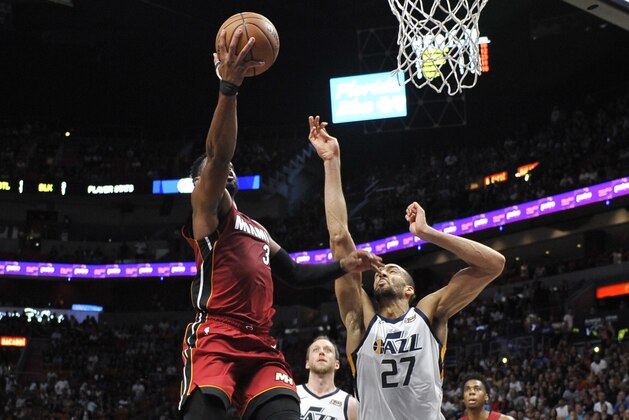 Miami Heat's Dwyane Wade (3) goes for a lay up against Utah Jazz center Rudy Gobert (27) in the second half of an NBA basketball game Sunday, Dec. 2, 2018, in Miami. (AP Photo/Gaston De Cardenas)