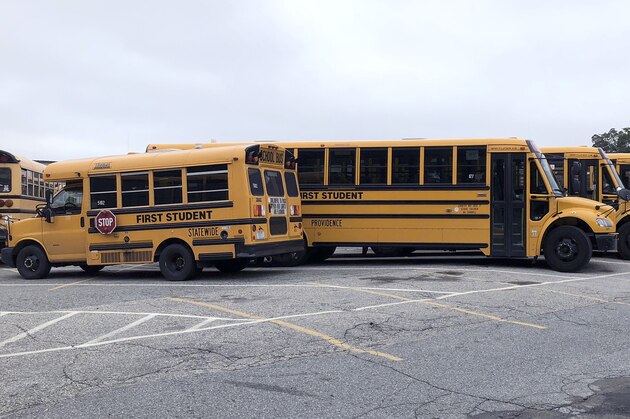 School buses sit idle on the fifth day of a strike by school bus drivers, Wednesday, Oct. 3, 2018, in Providence, R.I. The union that represents 200 bus drivers, Teamsters Local 251, began the strike Thursday after negotiations with management over retirement benefits failed. (AP Photo/Jennifer McDermott)