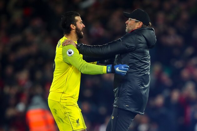 LIVERPOOL, ENGLAND - DECEMBER 02: Jurgen Klopp the manager / head coach of Liverpool celebrates with Alisson Becker of Liverpool as Divock Origi of Liverpool scores a goal to make it 1-0 during the Premier League match between Liverpool FC and Everton FC at Anfield on December 2, 2018 in Liverpool, United Kingdom. (Photo by Robbie Jay Barratt - AMA/Getty Images)