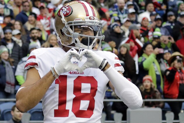 San Francisco 49ers wide receiver Dante Pettis (18) makes a heart shape with his hands after he scored a touchdown against the Seattle Seahawks during the second half of an NFL football game, Sunday, Dec. 2, 2018, in Seattle. (AP Photo/John Froschauer)