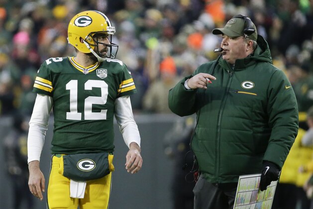 Green Bay Packers head coach Mike McCarthy talks to Aaron Rodgers during the first half of an NFL football game against the Miami Dolphins Sunday, Nov. 11, 2018, in Green Bay, Wis. (AP Photo/Mike Roemer)