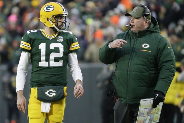 Green Bay Packers head coach Mike McCarthy talks to Aaron Rodgers during the first half of an NFL football game against the Miami Dolphins Sunday, Nov. 11, 2018, in Green Bay, Wis. (AP Photo/Mike Roemer)