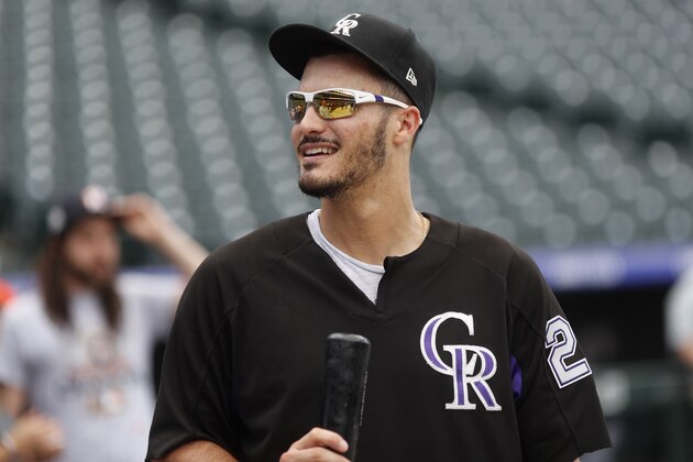 In this Tuesday, July 24, 2018, photo, Colorado Rockies' Nolan Arenado warms up before a baseball game against the Houston Astros in Denver. Arenado believes he's wired for winning just a little more intensely than others. (AP Photo/David Zalubowski)