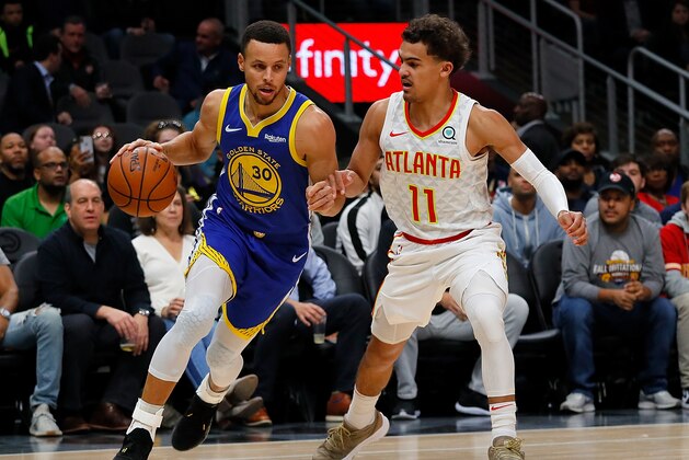 ATLANTA, GA - DECEMBER 03:  Stephen Curry #30 of the Golden State Warriors drives against Trae Young #11 of the Atlanta Hawks at State Farm Arena on December 3, 2018 in Atlanta, Georgia.  NOTE TO USER: User expressly acknowledges and agrees that, by downloading and or using this photograph, User is consenting to the terms and conditions of the Getty Images License Agreement.  (Photo by Kevin C. Cox/Getty Images)