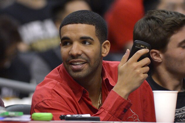 Singer Drake watches the Toronto Raptors play the Los Angeles Clippers during the first half of an NBA basketball game, Friday, Feb. 7, 2014, in Los Angeles. (AP Photo/Mark J. Terrill)