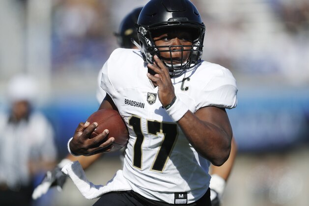 FILE - In this Nov. 4, 2017, file photo, Army quarterback Ahmad Bradshaw runs past Air Force defenders for a touchdown in the first half of an NCAA college football game, at Air Force Academy, Colo. The Black Knights (8-3) enter the 118th meeting with Navy on Saturday as a bowl-bound team again, holding a better record than the Midshipmen (6-5) for the first time since 2001. (AP Photo/David Zalubowski, File)