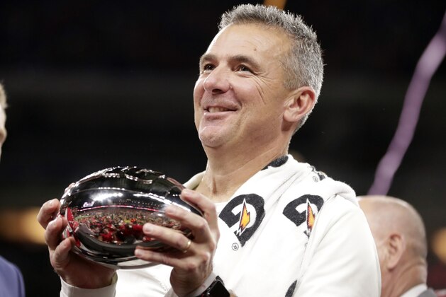 Ohio State head coach Urban Meyer holds the trophy after Ohio State defeated Northwestern in the Big Ten championship NCAA college football game, early Sunday, Dec. 2, 2018, in Indianapolis. Ohio State won 45-24. (AP Photo/Michael Conroy)