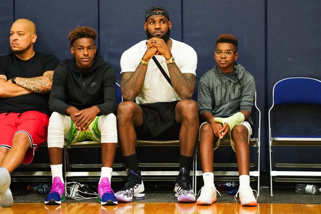 LAS VEGAS, NV - JULY 26:  (L-R) LeBron James Jr., LeBron James Sr. and Bryce Maximus James watch Zaire Wade’s AAU game court side at the Fab 48 tournament at Bishop Gorman High School on July 26, 2018 in Las Vegas, Nevada.  (Photo by Cassy Athena/Getty Images)