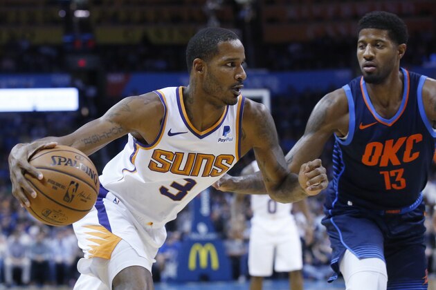 Phoenix Suns forward Trevor Ariza (3) drives around Oklahoma City Thunder forward Paul George (13) in the first half of an NBA basketball game in Oklahoma City, Sunday, Oct. 28, 2018. (AP Photo/Sue Ogrocki)