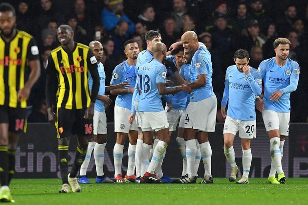 Manchester City's German midfielder Leroy Sane (5R) is mobbed by teammates after scoring the opening goal during the English Premier League football match between Watford and Manchester City at Vicarage Road Stadium in Watford, north of London on December 4, 2018. (Photo by Ben STANSALL / AFP) / RESTRICTED TO EDITORIAL USE. No use with unauthorized audio, video, data, fixture lists, club/league logos or 'live' services. Online in-match use limited to 120 images. An additional 40 images may be used in extra time. No video emulation. Social media in-match use limited to 120 images. An additional 40 images may be used in extra time. No use in betting publications, games or single club/league/player publications. /         (Photo credit should read BEN STANSALL/AFP/Getty Images)
