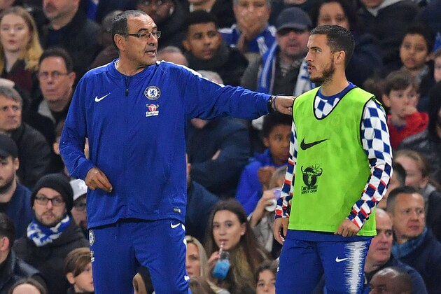 Chelsea's Italian head coach Maurizio Sarri (L) speaks with Chelsea's Belgian midfielder Eden Hazard (R) as he prepares to come on as a substitute during the English Premier League football match between Chelsea and Crystal Palace at Stamford Bridge in London on November 4, 2018. (Photo by Ben STANSALL / AFP) / RESTRICTED TO EDITORIAL USE. No use with unauthorized audio, video, data, fixture lists, club/league logos or 'live' services. Online in-match use limited to 120 images. An additional 40 images may be used in extra time. No video emulation. Social media in-match use limited to 120 images. An additional 40 images may be used in extra time. No use in betting publications, games or single club/league/player publications. /         (Photo credit should read BEN STANSALL/AFP/Getty Images)