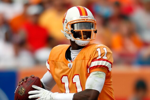 TAMPA, FL - DECEMBER 04:  Quarterback Josh Johnson #11 of the Tampa Bay Buccaneers looks for an open receiver against the Carolina Panthers during the game at Raymond James Stadium on December 4, 2011 in Tampa, Florida.  (Photo by J. Meric/Getty Images)