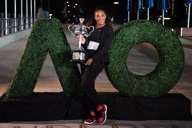 Serena Williams of the US poses with the championship trophy after her victory against Venus Williams of the US in the women's singles final on day 13 of the Australian Open tennis tournament in Melbourne on January 29, 2017. / AFP / SAEED KHAN / IMAGE RESTRICTED TO EDITORIAL USE - STRICTLY NO COMMERCIAL USE        (Photo credit should read SAEED KHAN/AFP/Getty Images)