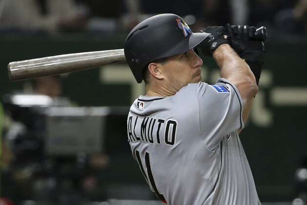 MLB All-Star catcher J.T. Realmuto of the Miami Marlins hits a solo home-run off Yomiuri Giants pitcher Ryusei Oe in the fifth inning of their exhibition baseball game at Tokyo Dome in Tokyo, Thursday, Nov. 8, 2018. (AP Photo/Toru Takahashi)