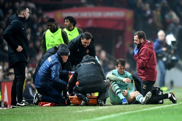MANCHESTER, ENGLAND - DECEMBER 05:  Rob Holding of Arsenal receives medical treatment during the Premier League match between Manchester United and Arsenal FC at Old Trafford on December 5, 2018 in Manchester, United Kingdom.  (Photo by Michael Regan/Getty Images)
